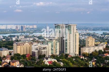 Air pollution by smoke coming out of two factory chimneys. Industrial zone in the city. Kiev, Ukraine, aerial view Stock Photo