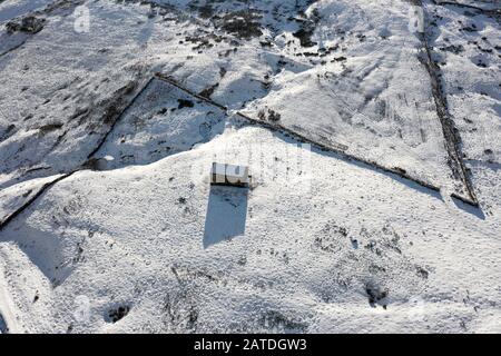 Aerial shot of a barn in the midst of winter Stock Photo
