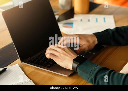 Male Hands Working On Laptop Typing At Workplace In Office Stock Photo