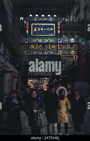 Beijing, China - December 26 2018: Group of people at the entrance of Wangfujing Street, the busiest Commercial Street in Beijing Stock Photo