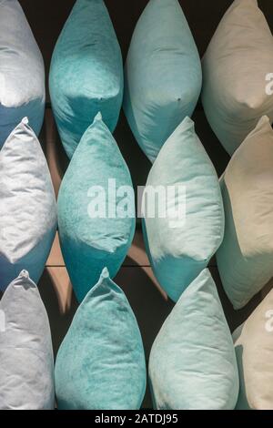 Multi-colored pillows background. Creative background made of pillows. Purple, blue, beige, gray pillows. vacation concept. vertical photo. Stock Photo