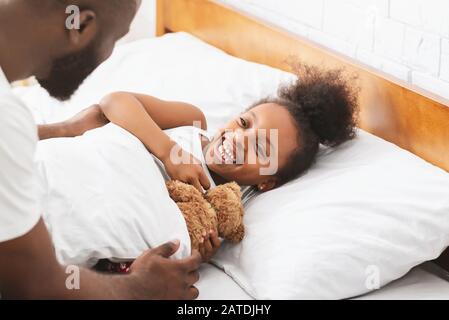 Cute little girl happy to see dad in the morning Stock Photo