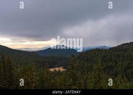 Forest and mountain landscape on a rainy day seen from Crater Lake Stock Photo