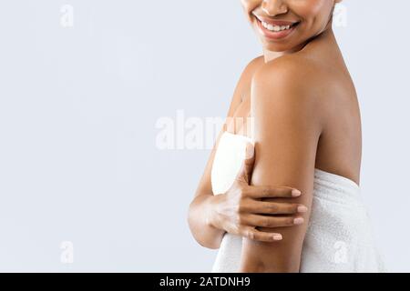 Close up of young beautiful woman touching her silky arms Stock Photo