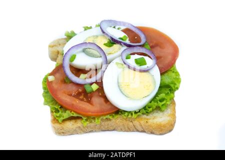 Sandwich with lettuce, eggs, tomatoes and purple onions. Isolated on a white background Stock Photo