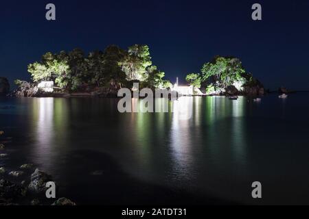 Viewed here is Panagia Island in low light. Set about 100 metres or so from Parga Town shoreline people can either swim or row to the small church th. Stock Photo