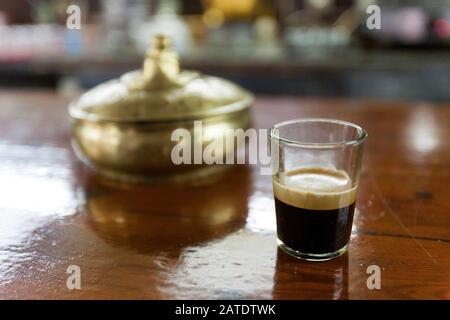 A short strong glass of black coffee and a bowl of sugar in a cafe in Bejaia, the port city on Algeria's northern Mediterranean coast. Stock Photo