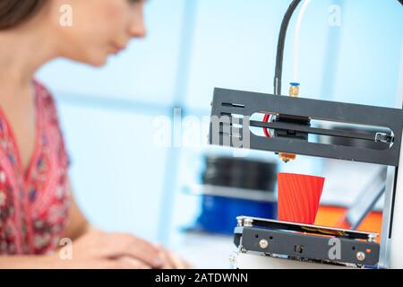 Young female designer works with a home 3D printer Stock Photo