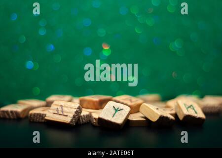 Group of old wooden runes on a green bokeh background Stock Photo