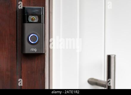 Brilon, North Rhine Westphalia / Germany - December 20th 2019:A modern surveillance camera is installed on a front door. Stock Photo