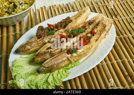 Puerto Rican  Stuffed Baked Plantains, roasted plantains filled with seasoned ground meat, tomatoes, onions, bell pepper, and spices Stock Photo