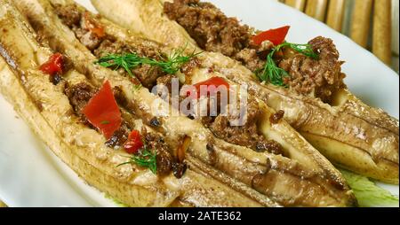 Puerto Rican  Stuffed Baked Plantains, roasted plantains filled with seasoned ground meat, tomatoes, onions, bell pepper, and spices Stock Photo