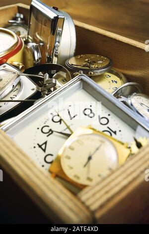 Different vintage mechanical watches, details for clock and alarm clock in the wooden box Stock Photo