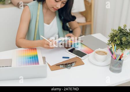 Stylish beautiful girl in designer clothes. She wore a tunic, blue lace. It  is made in the technology of nunovolok on white rarefied silk of merino wo  Stock Photo - Alamy