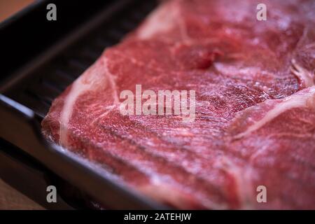 Raw beef meat slices on plate Stock Photo