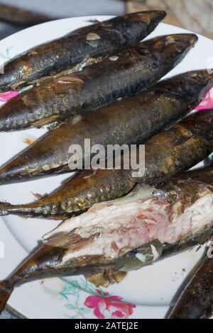 Smoked fresh fish mackerel lies hot on a ceramic plate Stock Photo