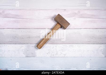 Hammer mason or mass on a background of old boards. Top view. Stock Photo