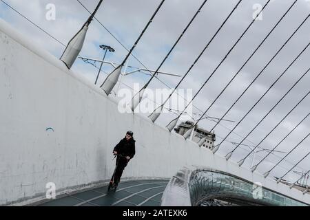 Jerusalem, Israel. 2nd February, 2020. A young man rides a scooter on Jerusalem’s Chords Bridge, also called the Bridge of Strings, designed by Spanish architect Santiago Calatrava and inaugurated in 2008. Credit: Nir Alon/Alamy Live News. Stock Photo