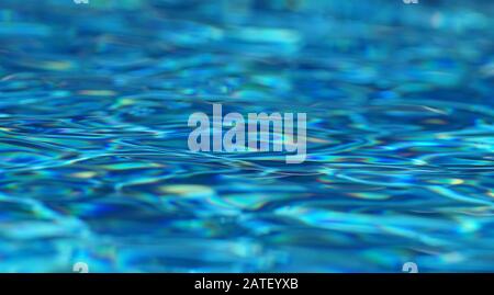 Abstract Beautiful blue pool water with reflections in many colors and ripples in the water Stock Photo