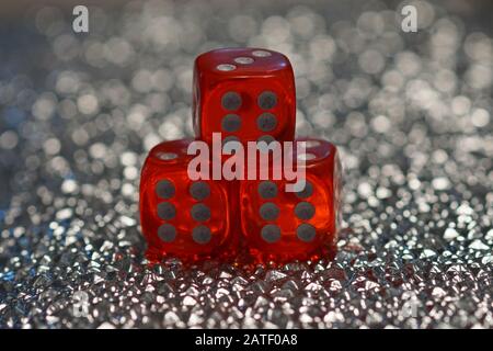 Triple six three red playing dices on number 6 on a bright and silver bokeh background Stock Photo