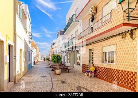 Typical  Fuseta side back street and café restaurant in, Fuseta, Algarve, Portugal. Stock Photo