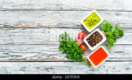Set sauces and spices. On a wooden background. Top view. Free space for your text. Stock Photo