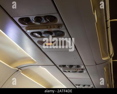 No smoking crossed out cigarette symbol turned on inside passenger airplane Stock Photo