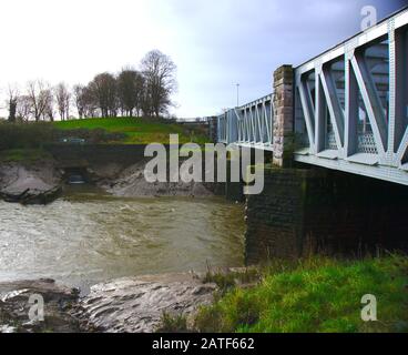 Ashton Avenue Bridge crossing brown water in the New Cut section of the River Avon, Bristol, UK. Stock Photo