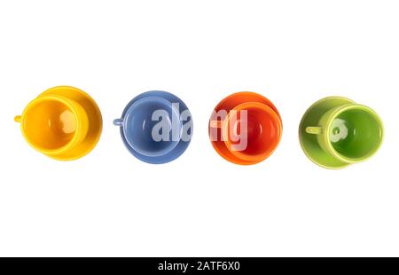 Four different colour empty coffee ceramic cups or tea cup isolated on white with clipping path. Empty space for text. Stock Photo