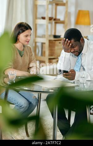 Financial consultant with young woman at table Stock Photo