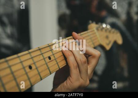 Playing Eric Clapton Blackie Replica Fender electric guitar on Marshall amp Stock Photo