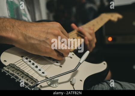 Playing Eric Clapton Blackie Replica Fender electric guitar on Marshall amp Stock Photo