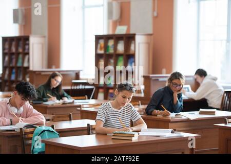 Several college students making notes while preparing for seminar Stock Photo