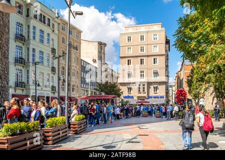 Travelers and tourists wait in the long line to enter the Galata Tower in the Karakoy district of Istanbul, Turkey. Stock Photo
