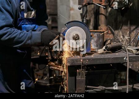 Abrasive machining manually on an power grinding wheel Stock Photo