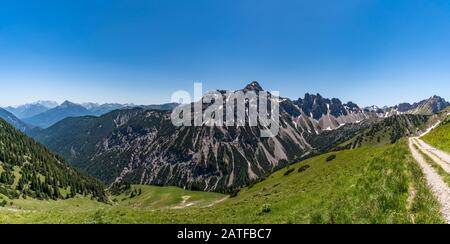 Fantastic hike in the Tannheim Mountains from the summit of Neunerkopfle over Landsberger hut to the beautiful Vilsalpsee. Stock Photo