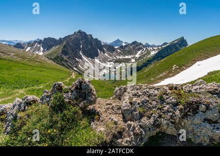 Fantastic hike in the Tannheim Mountains from the summit of Neunerkopfle over Landsberger hut to the beautiful Vilsalpsee. Stock Photo