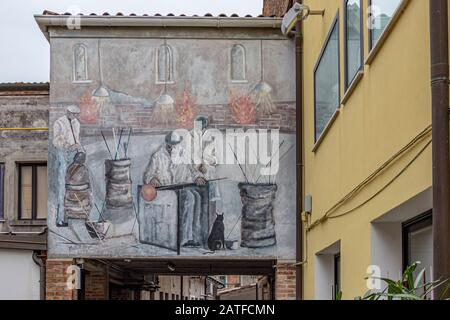 A painted wall showing glass blowers at work on the Island of Murano , famous the world over for its glassmaking,Murano ,Italy Stock Photo