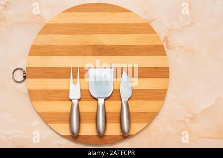 round wooden tray with flatware setting for cheese Stock Photo