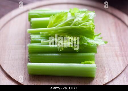 Stalks of fresh celery on a cutting Board. Stock Photo