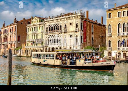 A route 2 Vaporetto busy with passengers,passing the Ca' d'Oro, a Venetian Gothic palace on The Grand Canal ,in the Cannaregio district ,Venice Italy Stock Photo