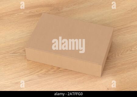 Blank cardboard wide flat box with closed hinged flap lid on wooden background. Clipping path around box mock up Stock Photo