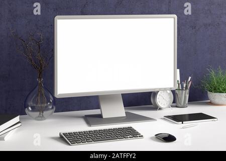 Workspace with blank computer monitor white screen mock up on the white desk near blue wall. monitor; screen; computer; mock up; Stock Photo