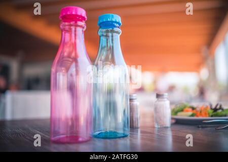 Two Reusable Plastic Drink Bottles on a table. Concept of recycling. Enviroment conservation. Stock Photo