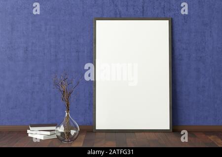 Blank vertical poster frame mock up standing on dark parquet floor next to blue wall with vase and books. Clipping path around poster Stock Photo