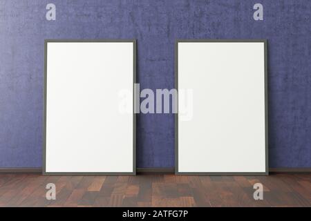 Two blank vertical posters. frame mock up standing on dark parquet floor next to blue wall. Clipping path around posters Stock Photo