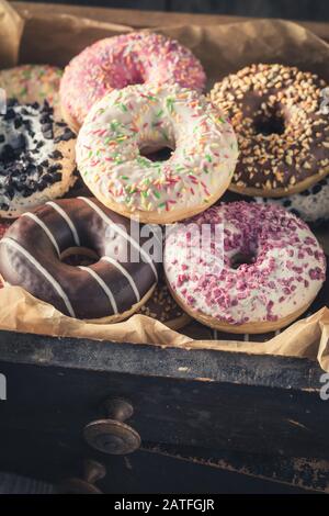 Assorted Sweet Donuts in a Paper Cardboard Box on a white background ...
