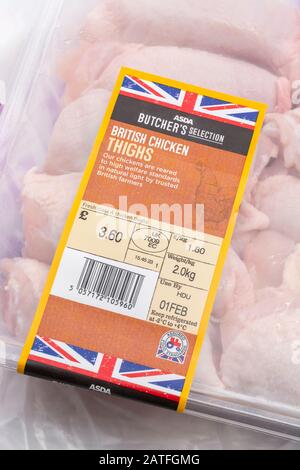 Plastic film wrapped ASDA chicken thighs with Union Jack graphic - British farm produce concept, food label close up, Use By date, food packaging Stock Photo