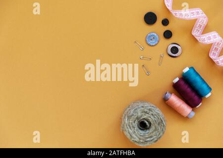 Group of sewing objects lying flat on a colorful background. Horizontal background for ad or packaging Stock Photo