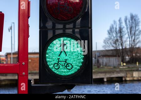 Green pedestrian and cyclist traffic light on bascule bridge, Four Bridges, Birkenhead Stock Photo
